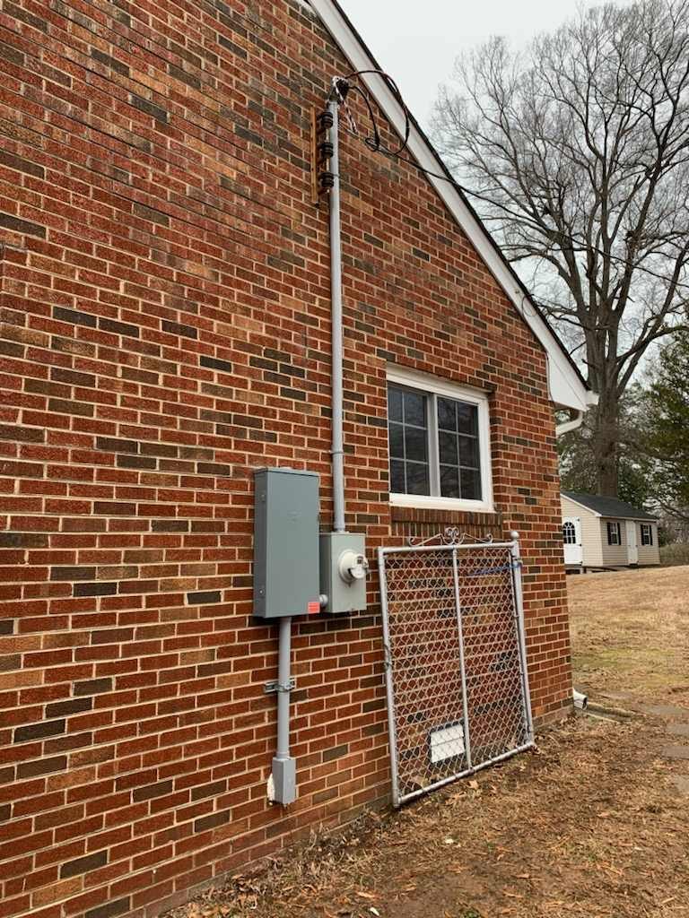 Meter and disconnect installed on a brick wall